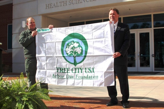 Ethan Robertson of the Georgia Forestry Commission presents City Manager Larry Hanson with the Tree City USA flag. This year marks the 29th consecutive year that the City of Valdosta has received the award for its management of trees in Valdosta's urban forest. In observance of Georgia Arbor Day, which is officially on February 20, Valdosta will fly the Tree City USA flags at the Police Department and at all Fire Department stations.